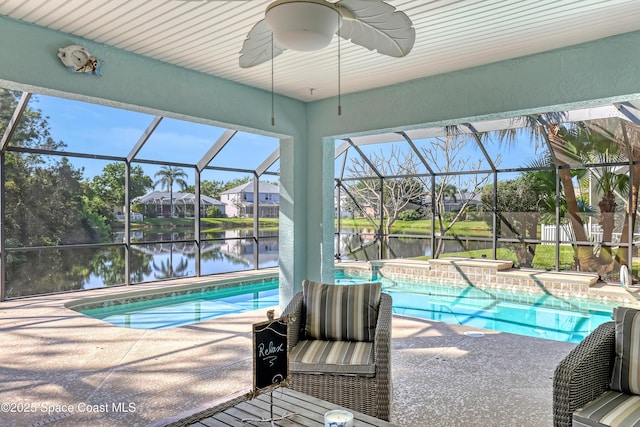 pool featuring a patio area, glass enclosure, a jacuzzi, and a water view