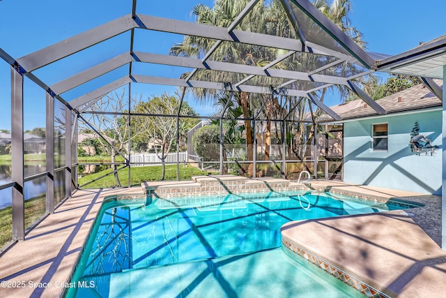 view of swimming pool featuring a fenced in pool, fence, a lanai, a patio area, and a jacuzzi