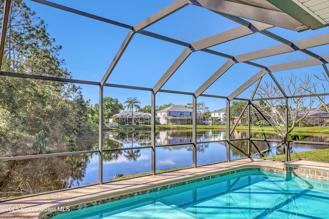 outdoor pool featuring a lanai, a residential view, a patio, and a water view