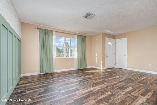 interior space featuring wood finished floors, visible vents, and baseboards