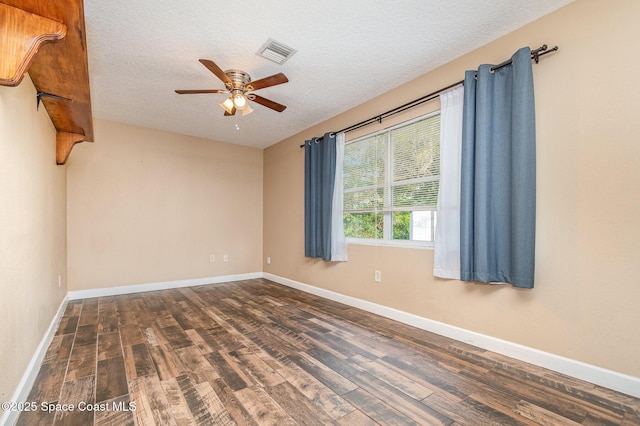 spare room with visible vents, a textured ceiling, ceiling fan, and wood finished floors