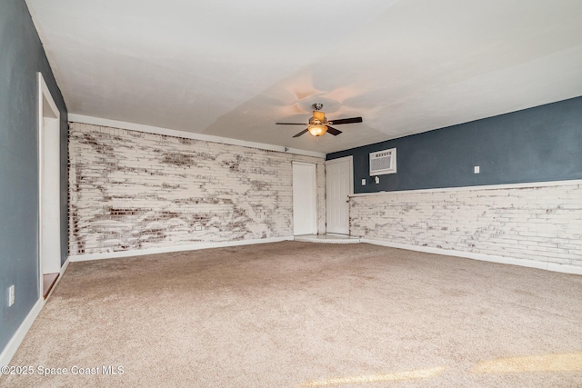 carpeted spare room with an AC wall unit and a ceiling fan