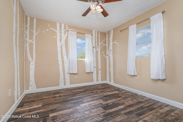 unfurnished room featuring baseboards, a textured ceiling, a ceiling fan, and wood finished floors