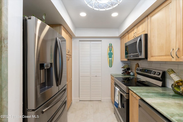 kitchen featuring recessed lighting, light brown cabinetry, stainless steel appliances, light countertops, and tasteful backsplash