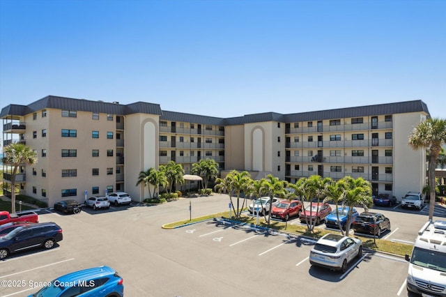 view of building exterior featuring uncovered parking