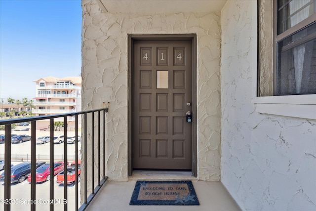 entrance to property featuring a balcony