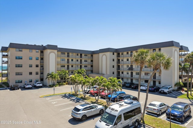 view of building exterior with uncovered parking