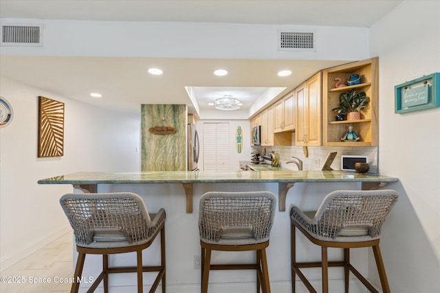 kitchen with decorative backsplash, open shelves, visible vents, and stainless steel appliances