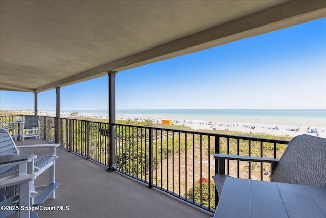 balcony featuring a water view and a view of the beach