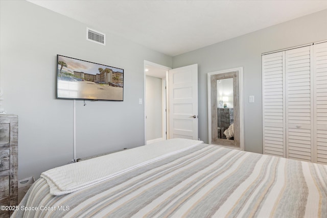 bedroom featuring visible vents and a closet