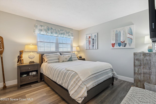 bedroom featuring baseboards and wood finished floors