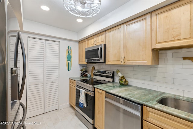 kitchen featuring light brown cabinets, recessed lighting, stainless steel appliances, decorative backsplash, and marble finish floor