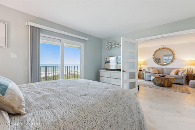 bedroom featuring marble finish floor and access to outside