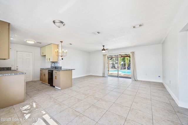 kitchen featuring visible vents, open floor plan, dishwasher, ceiling fan with notable chandelier, and a sink