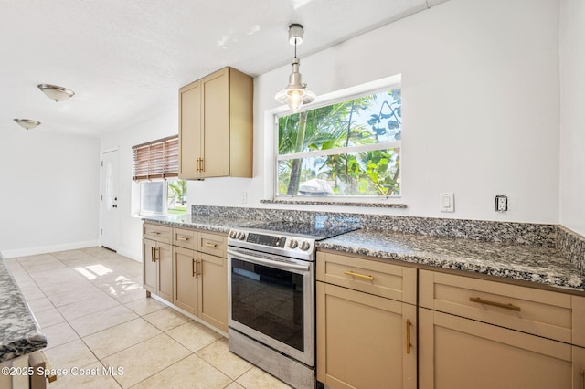 kitchen featuring pendant lighting, plenty of natural light, stainless steel range with electric stovetop, and light tile patterned flooring