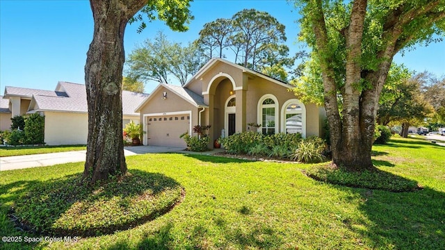 view of front of property featuring a front yard, concrete driveway, a garage, and stucco siding