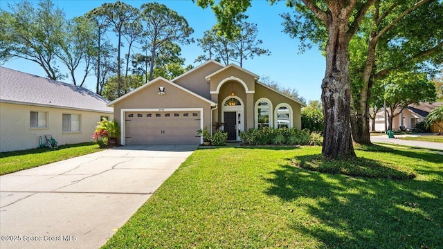 mediterranean / spanish house featuring stucco siding, a front yard, a garage, and driveway