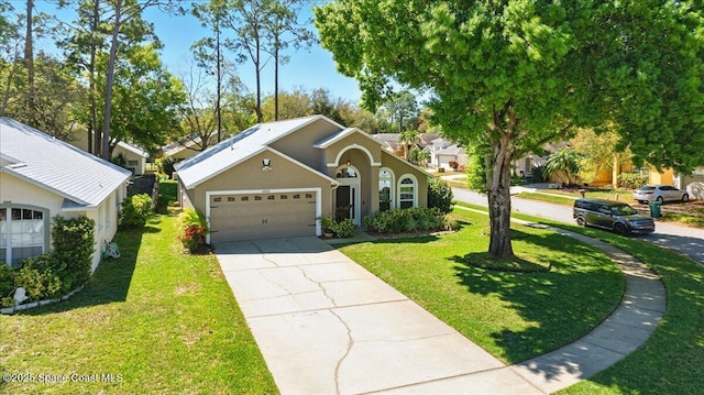 view of front of home with a front lawn, an attached garage, driveway, and stucco siding