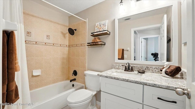 bathroom with visible vents, toilet, vanity, and shower / bath combo