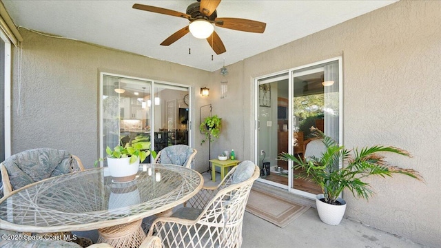 view of patio featuring ceiling fan