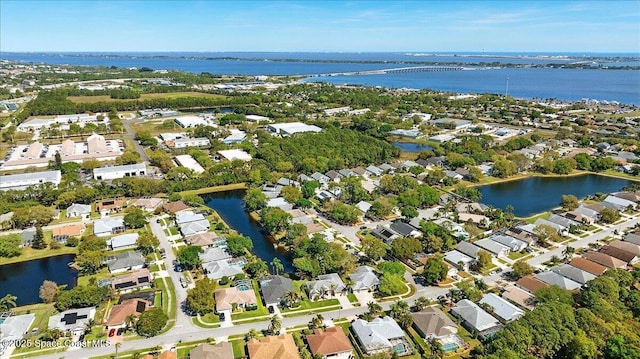 drone / aerial view featuring a residential view and a water view