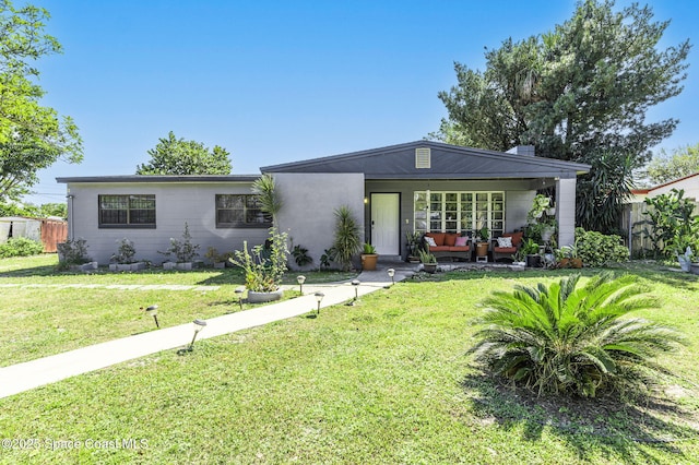 view of front of property with a front yard and fence