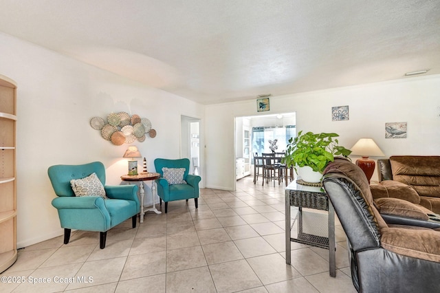 living room featuring light tile patterned flooring and a textured ceiling