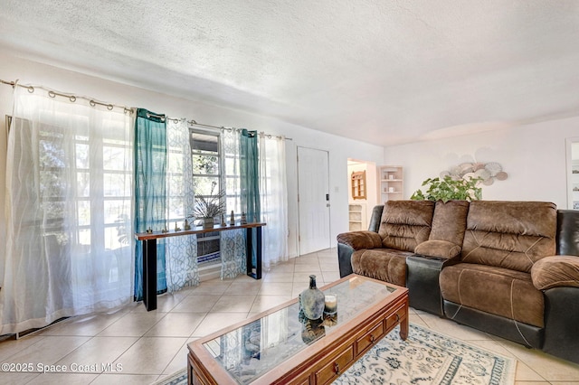 living room with light tile patterned floors and a textured ceiling