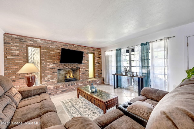 living area with light tile patterned flooring, a brick fireplace, and a textured ceiling