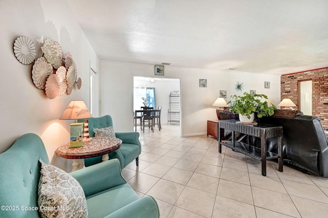 living area with light tile patterned floors, a textured ceiling, and baseboards