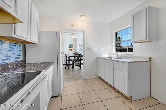 kitchen with backsplash, under cabinet range hood, light tile patterned floors, a ceiling fan, and a sink