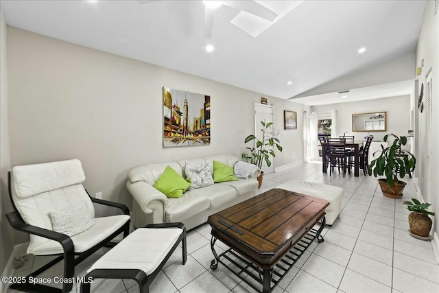 living area featuring light tile patterned floors, baseboards, vaulted ceiling with skylight, and recessed lighting