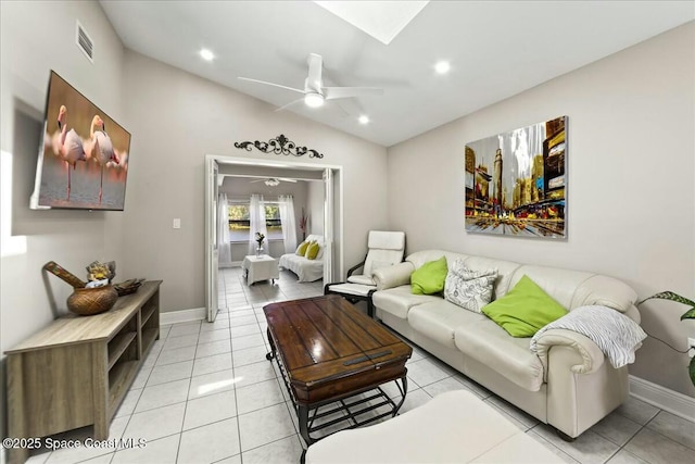 living room with vaulted ceiling, light tile patterned floors, visible vents, and ceiling fan