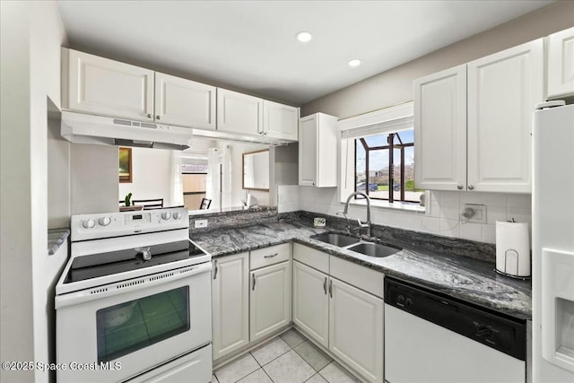 kitchen featuring under cabinet range hood, white appliances, white cabinets, and a sink