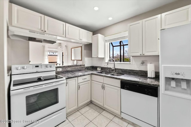 kitchen with under cabinet range hood, white cabinets, white appliances, and a sink