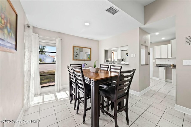 dining room featuring light tile patterned flooring, visible vents, recessed lighting, and baseboards