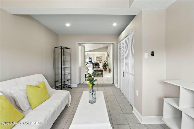 tiled living area with recessed lighting and baseboards