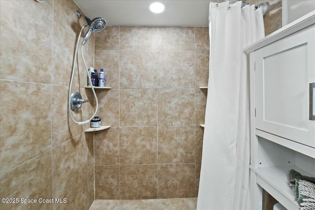 bathroom with a tile shower