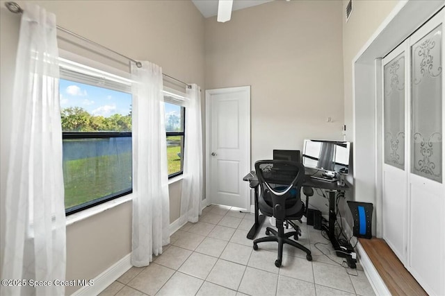 office area featuring light tile patterned flooring, visible vents, and baseboards