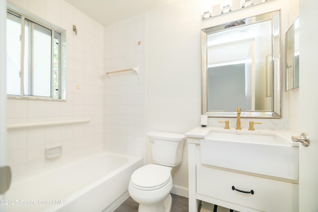 bathroom with baseboards, toilet, and vanity