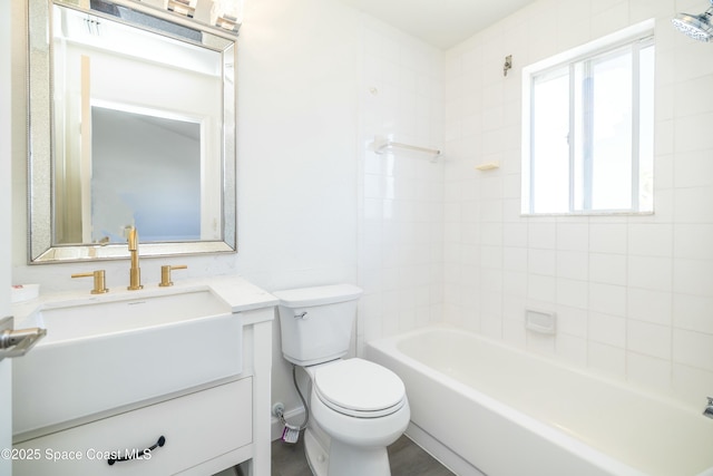 bathroom with toilet, vanity, and shower / bathing tub combination