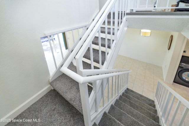 stairway featuring baseboards