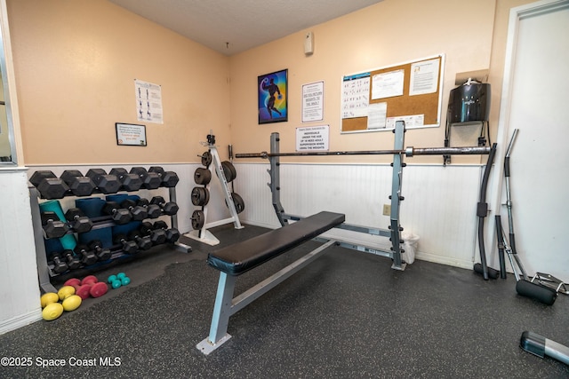 workout area featuring wainscoting