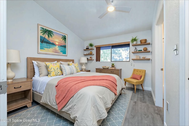 bedroom featuring ceiling fan, baseboards, dark wood finished floors, and vaulted ceiling