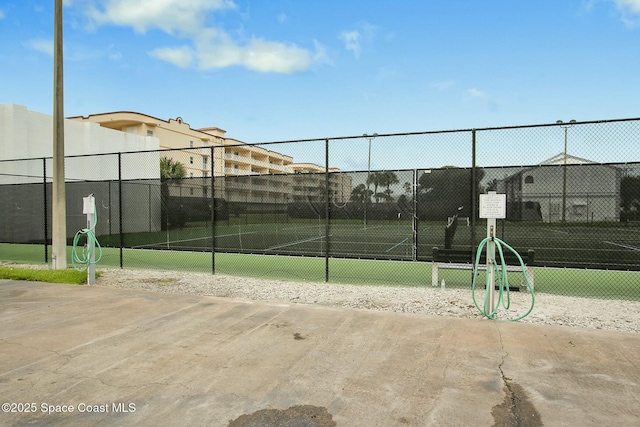 view of sport court featuring fence