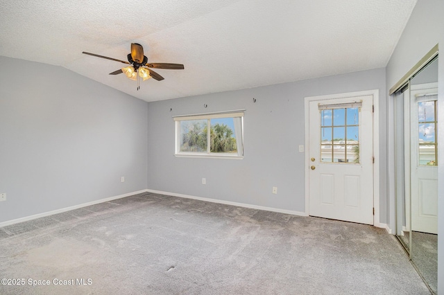 211 Cherie Down Ln, Cape Canaveral, FL 32920 - unfurnished room featuring a ceiling fan, plenty of natural light, carpet floors, a textured ceiling, and lofted ceiling