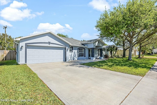 ranch-style home featuring an attached garage, fence, a front yard, stucco siding, and driveway