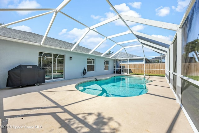 view of swimming pool featuring glass enclosure, a fenced in pool, fence, area for grilling, and a patio area