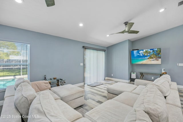 living area featuring recessed lighting, visible vents, baseboards, and ceiling fan