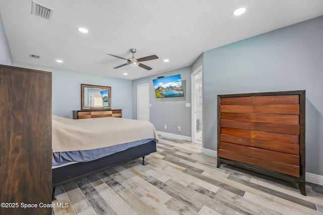 bedroom featuring wood finished floors, recessed lighting, visible vents, and baseboards